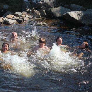 Family swimming in a pool on Dartmoor